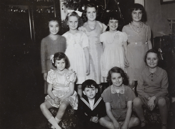 Marjorie Ephgrave with a group of children in front of a Christmas tree