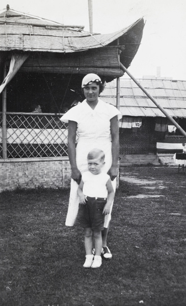 Frankie Bomko and a young boy in front of a matshed, Shanghai