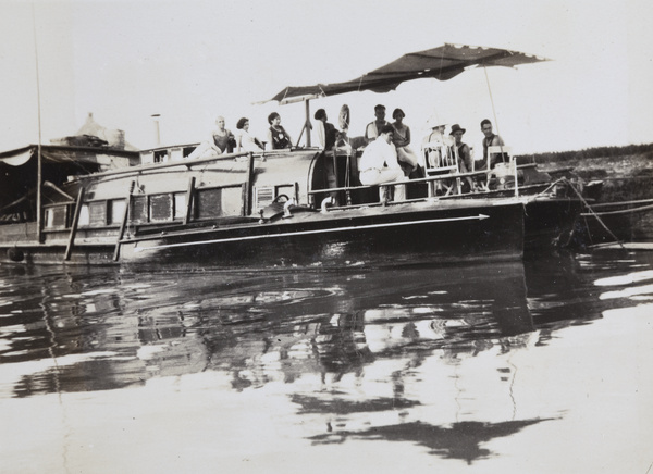 A motorboat beside a houseboat