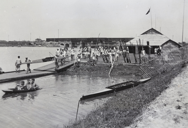 Shanghai Rowing Club oarsmen and boathouse, with a train on a railway bridge, Shanghai