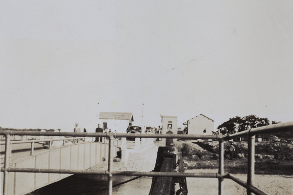 People and cars at a toll bridge