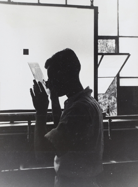 A man inspecting a glass plate with a lupe at a printing factory, Pudong, Shanghai