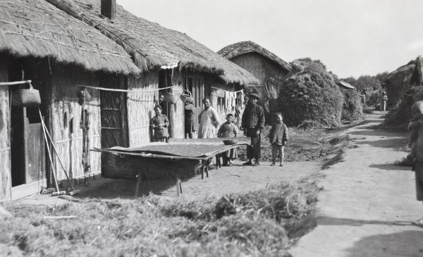 Villagers drying rice on a raised mat