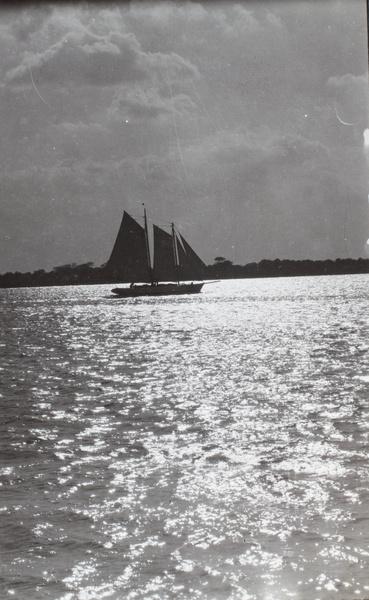 Boat sailing on a sun sparkly river