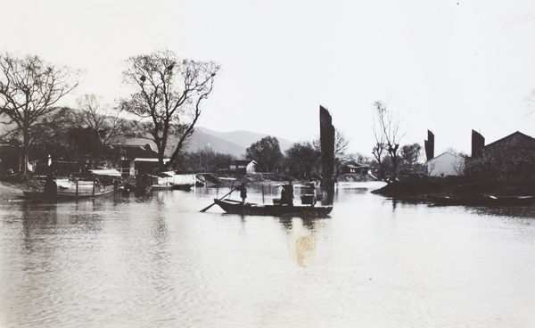 A ferry crossing a river, with pedlars as passengers