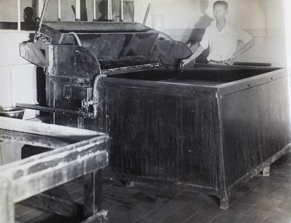 Worker with commercial printing equipment, Pudong, Shanghai