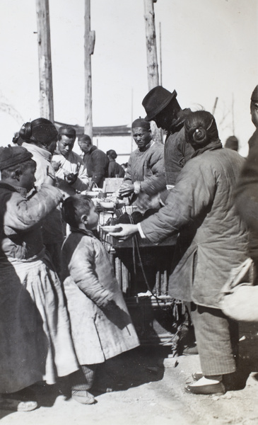 Street food cooks, with customers eating while standing