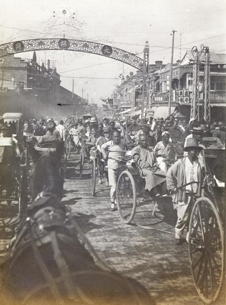 Rickshaw traffic on Jingang bridge (金鋼橋), with (大胡同 [Da Hutong]) in the background, Tianjin