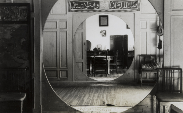 A dining room seen through two moon doors