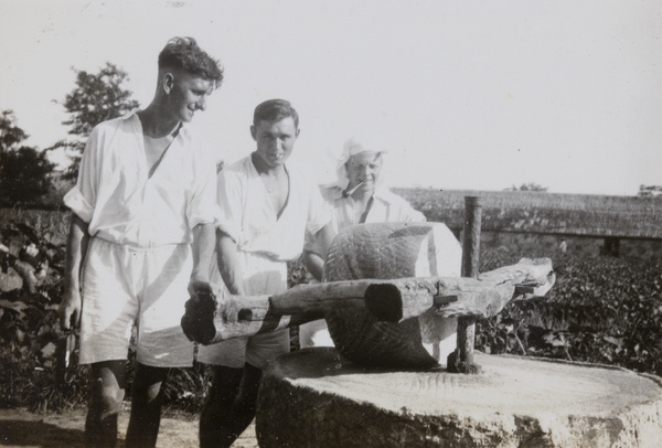 Royal Navy sailors by a millstone