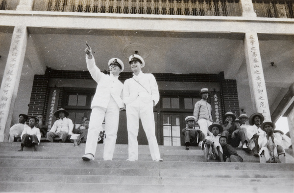 Two Royal Navy sailors outside a building