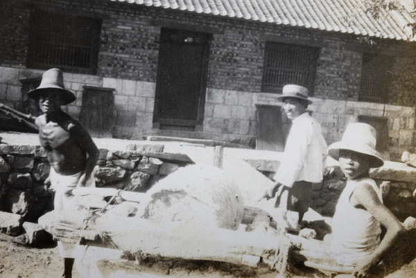 Three workers mixing cement