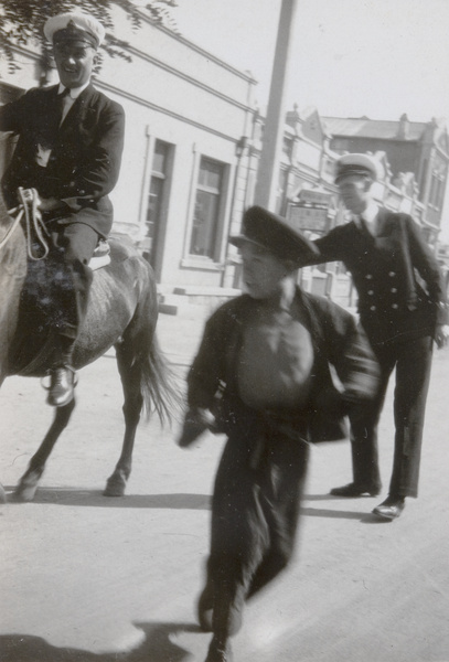 A boy with Royal Navy men, North China