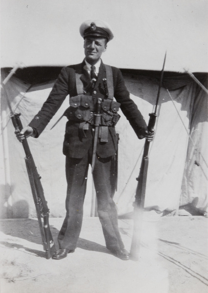 A Royal Navy sailor with two rifles, Stonecutters Island, Hong Kong