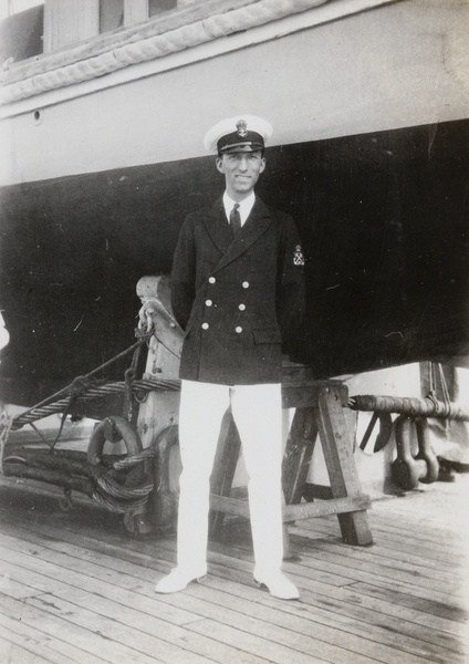 F. Hagger by a boat on a cradle, HMS Medway