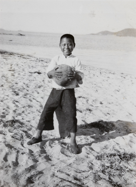 A boy with a foot ball on a beach, Weihai (威海)
