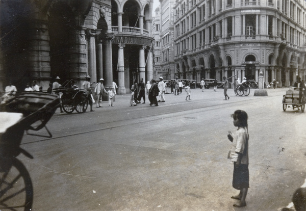 A girl standing on Des Voeux Road, Hong Kong