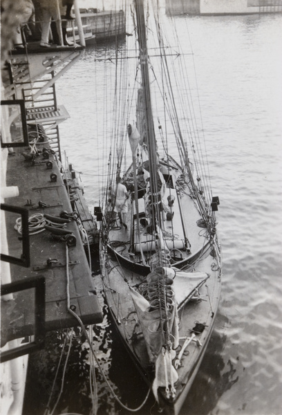 A yacht moored alongside a ship