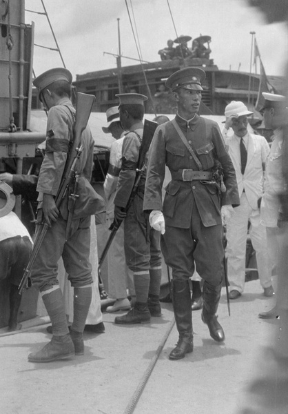 An officer and soldiers on a boat