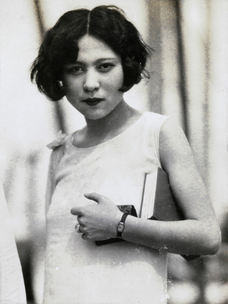 A woman, with book and purse