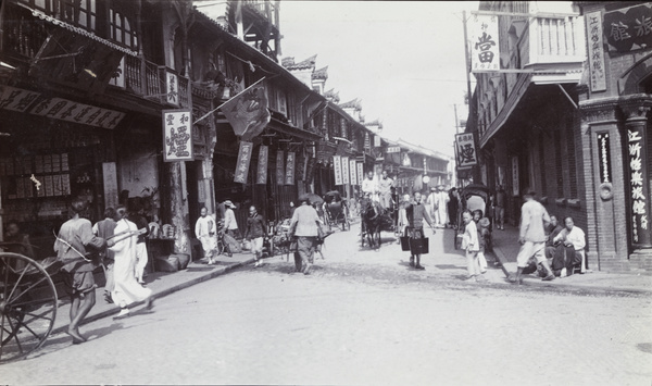 A shopping street with horse carriage, rickshaws, carter and water carrier, Shanghai