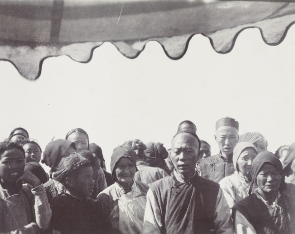 Onlookers photographed from a houseboat