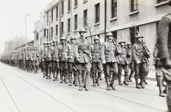 British troops (Shanghai Defence Force) marching along a street, Shanghai