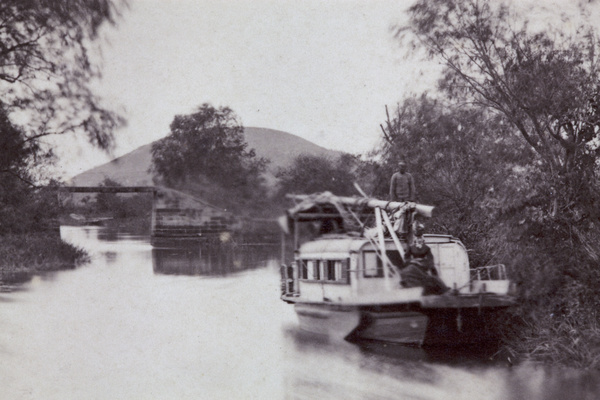 A houseboat and a stone beam bridge, near Shanghai