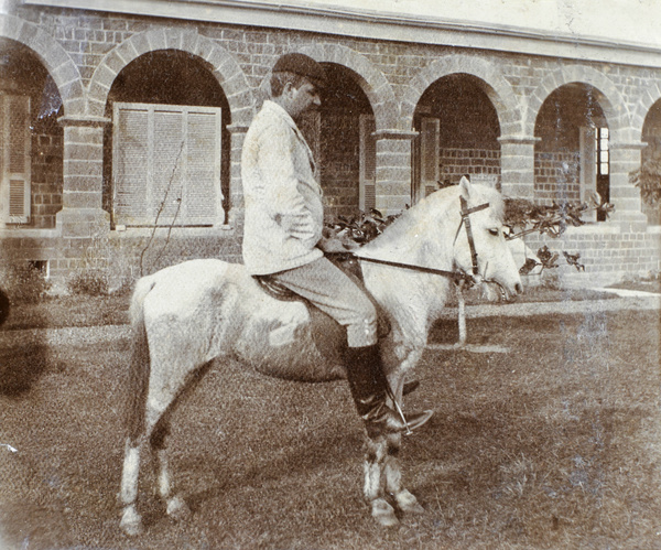 Dr J. H. Lowry and pony at Hoihow