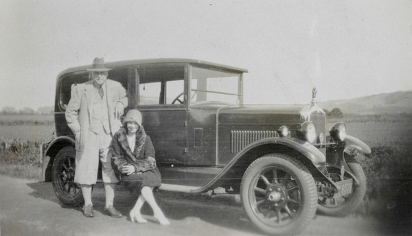 Hedgeland and a woman by a car