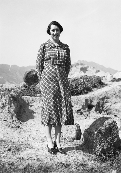 Lilian Thoresen modelling a tartan patterned dress, Hong Kong