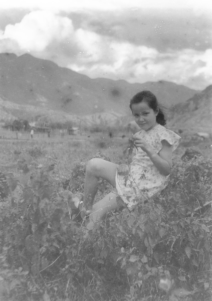 Kristine Thoresen sitting on a stone,  near the Army Sports Ground, Mongkok, Hong Kong