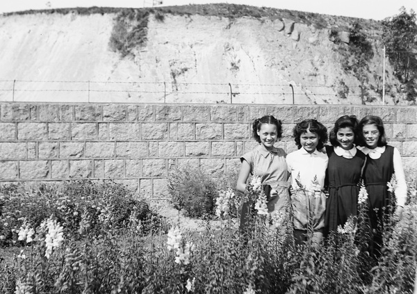 Four unidentified young women, two wearing school uniforms, Kowloon, Hong Kong