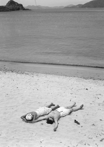 Lucy Shirazee and a friend sunbathing, South Bay Beach, Hong Kong