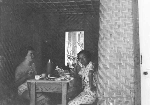 Lucy Shirazee and a friend having a meal in a beach hut, South Bay Beach, Hong Kong