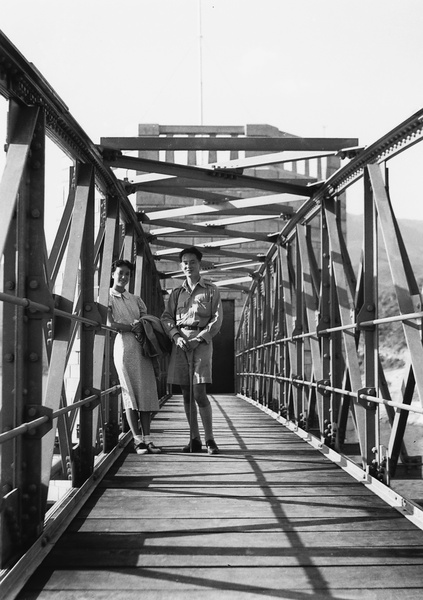 Unidentified young woman and man on a bridge, Shing Mun Reservoir, Hong Kong