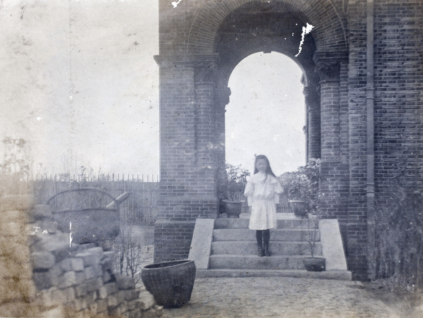 Lilian Hutchinson standing on steps to entrance of 35 Tongshan Road, Hongkou, Shanghai