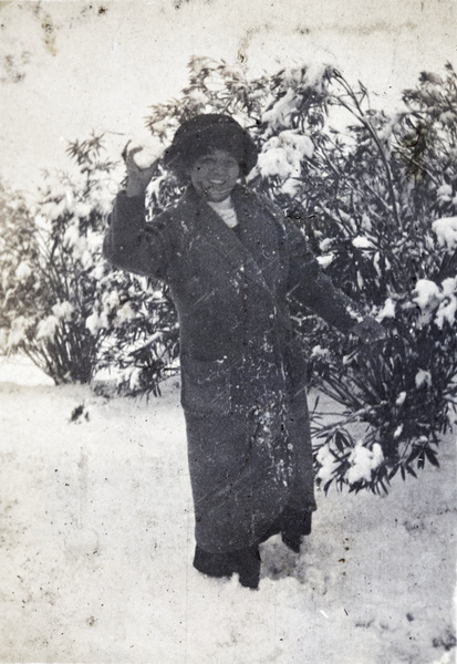 Woman throwing snowballs in the garden of 35 Tongshan Road, Hongkou, Shanghai