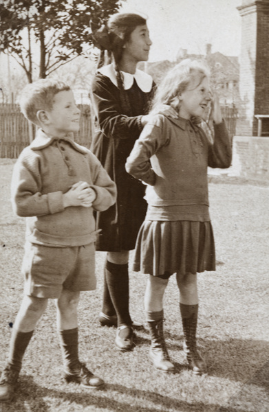 Maggie Hutchinson with two neighbouring children in the garden of 35 Tongshan Road, Hongkou, Shanghai