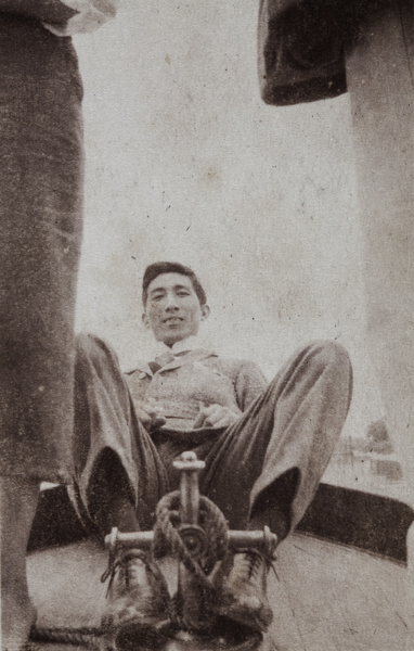 Tom Hutchinson posing behind a cross bollard on an excursion boat, Huangpu, Shanghai