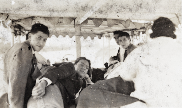 Group of friends under the canopy of an excursion boat, Shanghai