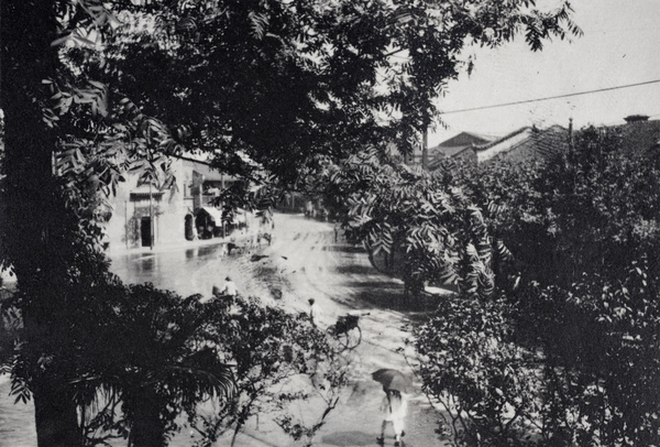 Pedestrians and a rickshaw walking past a flooded road, Shanghai