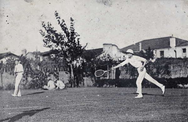 Mr Carrington playing a long tennis shot, Shanghai