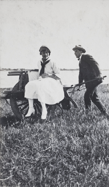 Charles Hutchinson pushing Gladys Gundry on a wheelbarrow, Wusong, near Shanghai