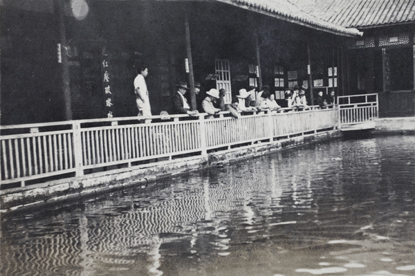 Tourists at a sacred fish pond, Hangzhou