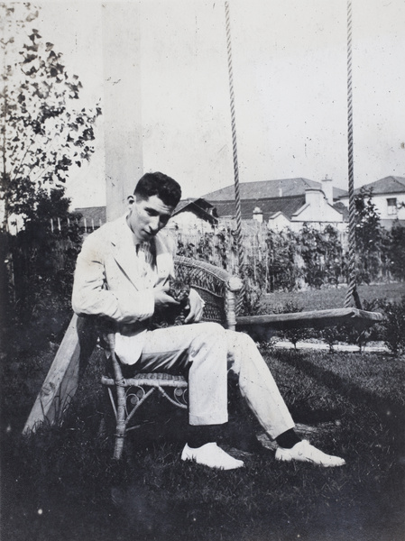 John Henderson with a kitten in the garden of 35 Tongshan Road, Hongkou, Shanghai