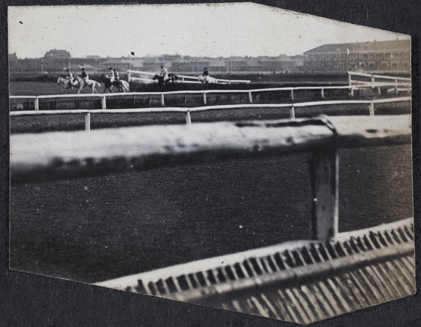 Horses racing around a steeplechase course, Shanghai Race Club