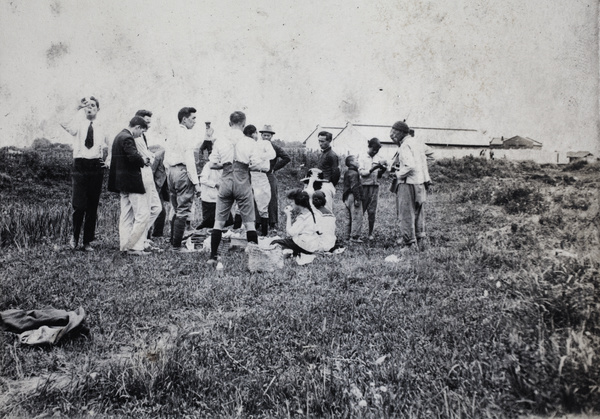 Chinese locals watching a group of friends picnicing on a day out, near Shanghai