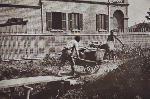 Two barrow men at a plank bridge over the ditch alongside 35 Tongshan Road, Hongkou, Shanghai