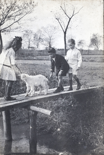 Fred Hutchinson and neighbouring children with two-headed conjoined goat kids, Hongkou, Shanghai